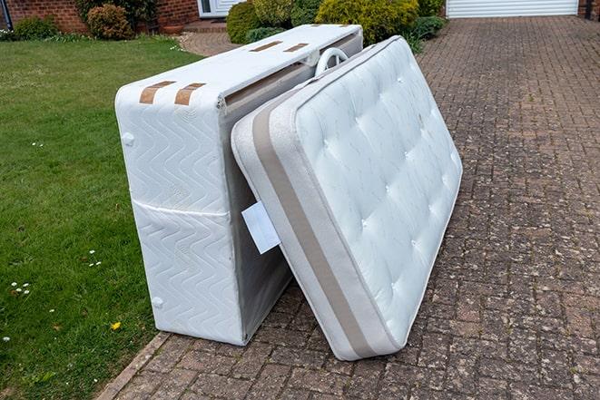 mattress strapped on top of a removal truck